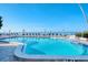 Relaxing beachfront pool with ocean view and lounge chairs at 800 Benjamin Franklin Dr # 202, Sarasota, FL 34236