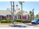 Yellow building housing Le Macaron French Pastries, surrounded by other shops at 800 Benjamin Franklin Dr # 202, Sarasota, FL 34236