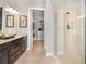 Spa-like bathroom with double vanity, large shower, and walk-in closet at 8040 Moonbeam Avenue, Sarasota, FL 34241
