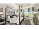 Spacious main bedroom with a cozy sitting area and large windows at 8040 Moonbeam Avenue, Sarasota, FL 34241