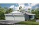 Two-story home with a three-car garage and landscaped front yard at 8125 Moonbeam Ave, Sarasota, FL 34241