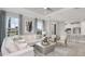 Bright living room with an open floor plan, white couch, and access to the kitchen at 8125 Moonbeam Ave, Sarasota, FL 34241