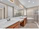 Elegant bathroom with double sinks, soaking tub, and glass shower at 8273 Shooting Star Rd, Sarasota, FL 34241