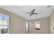 Bright bedroom with ceiling fan and multiple windows at 8273 Shooting Star Rd, Sarasota, FL 34241