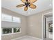 Spacious bedroom with ceiling fan and large windows at 8273 Shooting Star Rd, Sarasota, FL 34241