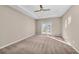 Large bedroom with plush carpeting and access to a private balcony at 8273 Shooting Star Rd, Sarasota, FL 34241