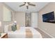 Bright bedroom featuring a comfortable bed and large TV at 8273 Shooting Star Rd, Sarasota, FL 34241