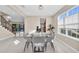 Modern dining room with glass table and grey chairs at 8273 Shooting Star Rd, Sarasota, FL 34241
