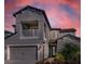 Two-story house with gray siding, balcony, and three-car garage at 8273 Shooting Star Rd, Sarasota, FL 34241