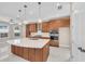 Modern kitchen with island, stainless steel appliances, and wood cabinets at 8273 Shooting Star Rd, Sarasota, FL 34241