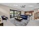 Bright living room with pool view, plush sofa, and large sliding glass doors at 8273 Shooting Star Rd, Sarasota, FL 34241