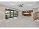 Bright and airy living room with view of pool and kitchen at 8273 Shooting Star Rd, Sarasota, FL 34241