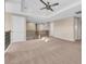 Spacious loft area with neutral carpeting and a ceiling fan at 8273 Shooting Star Rd, Sarasota, FL 34241