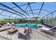 Covered patio with pool, spa, and lounge area at 8273 Shooting Star Rd, Sarasota, FL 34241