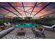 Sunset view of the relaxing pool and spa with covered patio at 8273 Shooting Star Rd, Sarasota, FL 34241