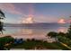 Lush backyard featuring manicured lawn, lounge chairs, and tranquil ocean views at 915 N Shore Dr, Anna Maria, FL 34216