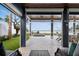 An outdoor patio showcases a view of a pool leading to the ocean at 915 N Shore Dr, Anna Maria, FL 34216