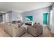 Spacious living room with comfortable seating and fireplace at 9810 Eventide Trl, Parrish, FL 34219
