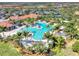 Aerial view of community pool, clubhouse, and tennis courts at 10031 Crooked Creek Dr # 201, Venice, FL 34293