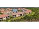 Wide angle aerial view of townhomes and lush green landscape at 10031 Crooked Creek Dr # 201, Venice, FL 34293
