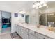 Elegant bathroom with double vanity, large mirror, and walk-in shower at 10031 Crooked Creek Dr # 201, Venice, FL 34293