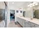 Elegant bathroom with double vanity, large mirror, and walk-in shower at 10031 Crooked Creek Dr # 201, Venice, FL 34293