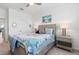 Bedroom with a queen bed, nightstand, and access to another room at 10031 Crooked Creek Dr # 201, Venice, FL 34293
