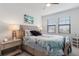Well-lit bedroom featuring a queen-size bed and ample natural light at 10031 Crooked Creek Dr # 201, Venice, FL 34293