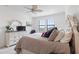 Bright bedroom with large windows, dresser, and comfortable bed at 10031 Crooked Creek Dr # 201, Venice, FL 34293