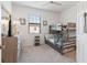 Cozy bedroom with full-over-full bunk bed, dresser, and TV at 10031 Crooked Creek Dr # 201, Venice, FL 34293
