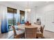 Charming dining room with round table and six wicker chairs, near balcony at 10031 Crooked Creek Dr # 201, Venice, FL 34293