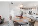 Kitchen and dining area with a round wooden table and white chairs at 10031 Crooked Creek Dr # 201, Venice, FL 34293