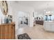 Bright and airy entryway with tile floors, a wooden cabinet, and views into the living area and a bedroom at 10031 Crooked Creek Dr # 201, Venice, FL 34293