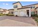 Townhome exterior featuring a two-car garage and inviting entryway at 10031 Crooked Creek Dr # 201, Venice, FL 34293