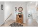 Light-filled hallway with tile flooring, a wooden cabinet, and access to other rooms at 10031 Crooked Creek Dr # 201, Venice, FL 34293