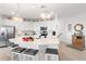 Modern white kitchen with stainless steel appliances and a large island with seating at 10031 Crooked Creek Dr # 201, Venice, FL 34293