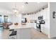 Modern white kitchen with stainless steel appliances and a large island at 10031 Crooked Creek Dr # 201, Venice, FL 34293