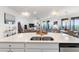 Modern kitchen island with double sink, overlooking the living room at 10031 Crooked Creek Dr # 201, Venice, FL 34293