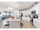 Modern white kitchen with stainless steel appliances and a large island at 10031 Crooked Creek Dr # 201, Venice, FL 34293