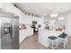 Modern white kitchen with stainless steel appliances and a large island at 10031 Crooked Creek Dr # 201, Venice, FL 34293