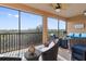 Relaxing screened lanai with wicker furniture and scenic views at 10031 Crooked Creek Dr # 201, Venice, FL 34293