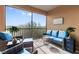 Screened lanai with wicker furniture and tranquil views at 10031 Crooked Creek Dr # 201, Venice, FL 34293
