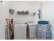 Laundry room with washer, dryer, and storage shelves at 10031 Crooked Creek Dr # 201, Venice, FL 34293