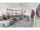 Spacious living room featuring a large sectional sofa and decorative Christmas tree at 10031 Crooked Creek Dr # 201, Venice, FL 34293