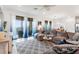 Bright living room with sectional sofa and access to a balcony at 10031 Crooked Creek Dr # 201, Venice, FL 34293