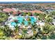 Large resort-style pool with surrounding lounge areas and palm trees at 10031 Crooked Creek Dr # 201, Venice, FL 34293
