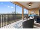 Enjoy outdoor living on this screened balcony with wicker furniture at 10031 Crooked Creek Dr # 201, Venice, FL 34293