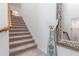 Carpeted staircase leading to the upper levels at 10031 Crooked Creek Dr # 201, Venice, FL 34293