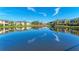 Community lakefront with building reflections, landscaping, and a bridge at 1105 Gondola Park Dr # 1105, Venice, FL 34292