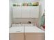 Laundry room with washer, dryer, and overhead cabinets at 1105 Gondola Park Dr # 1105, Venice, FL 34292